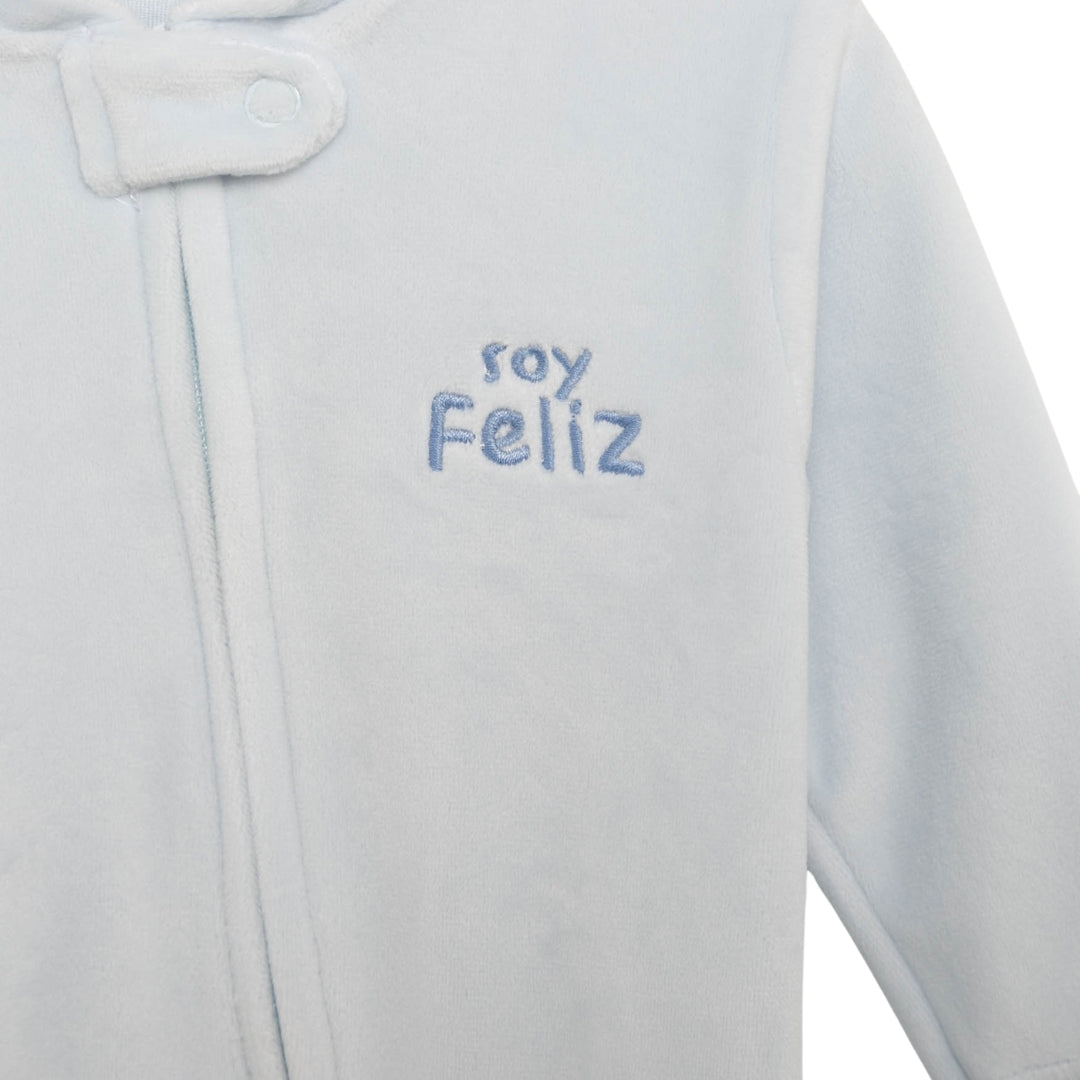Nahaufnahme des Zip-up Stramplers in Hellblau mit "soy feliz"-Stickerei und Teddybär-Stickerei auf der Rückseite.